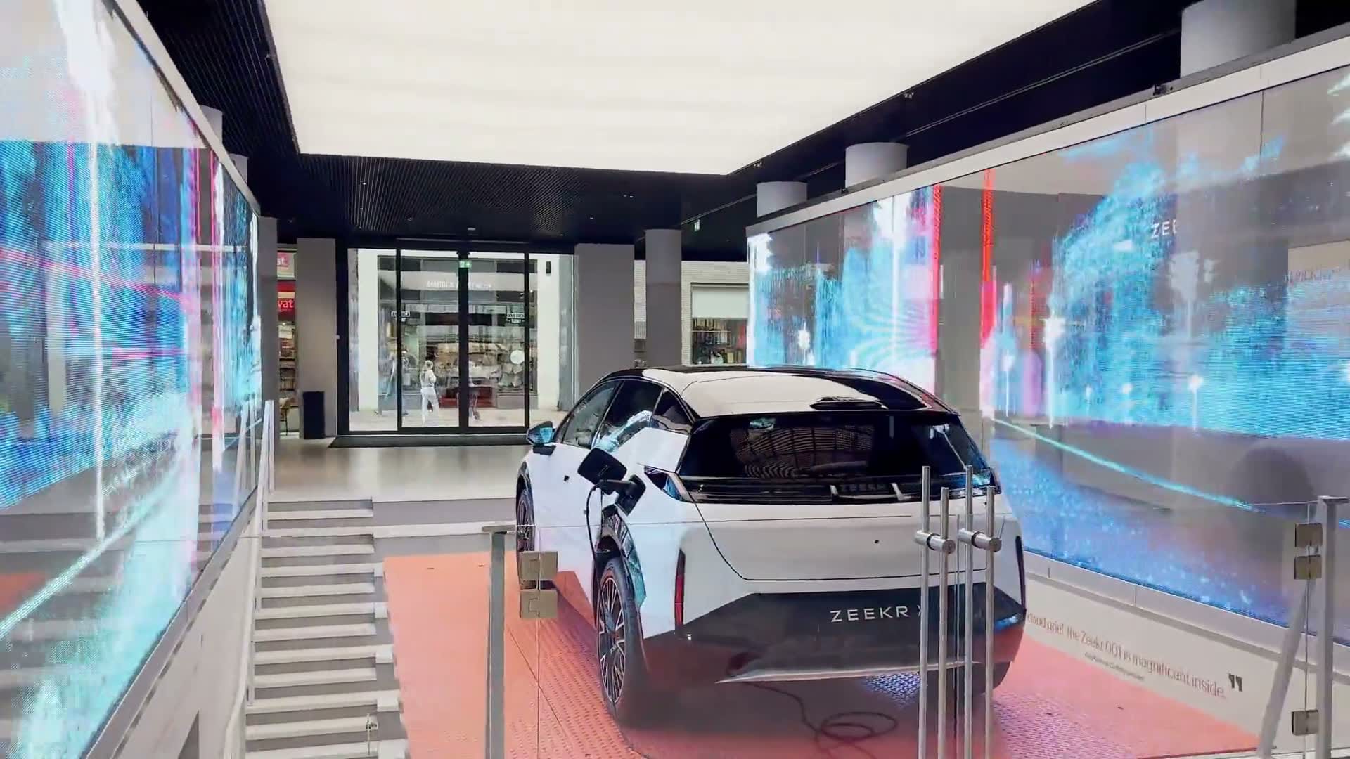 Transparent LED display walls running animated content in an automotive showroom